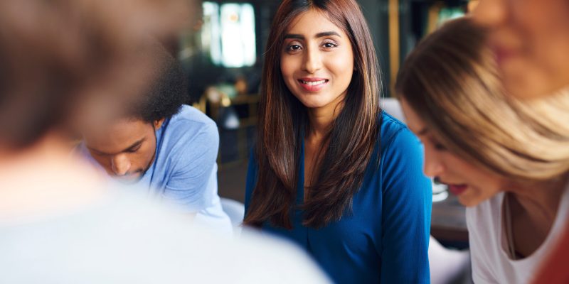 Portrait of beautiful Asian woman over work